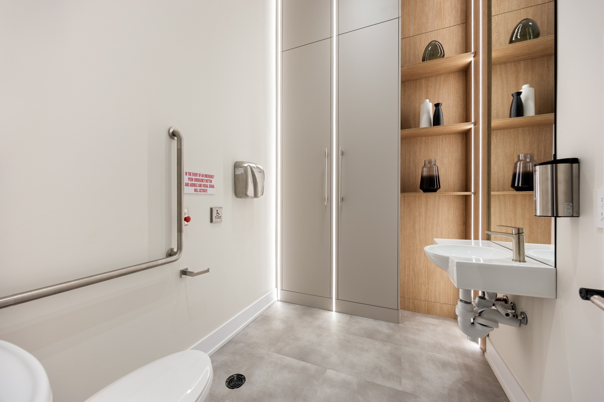 Completed accessible healthcare washroom with coordinated finishes